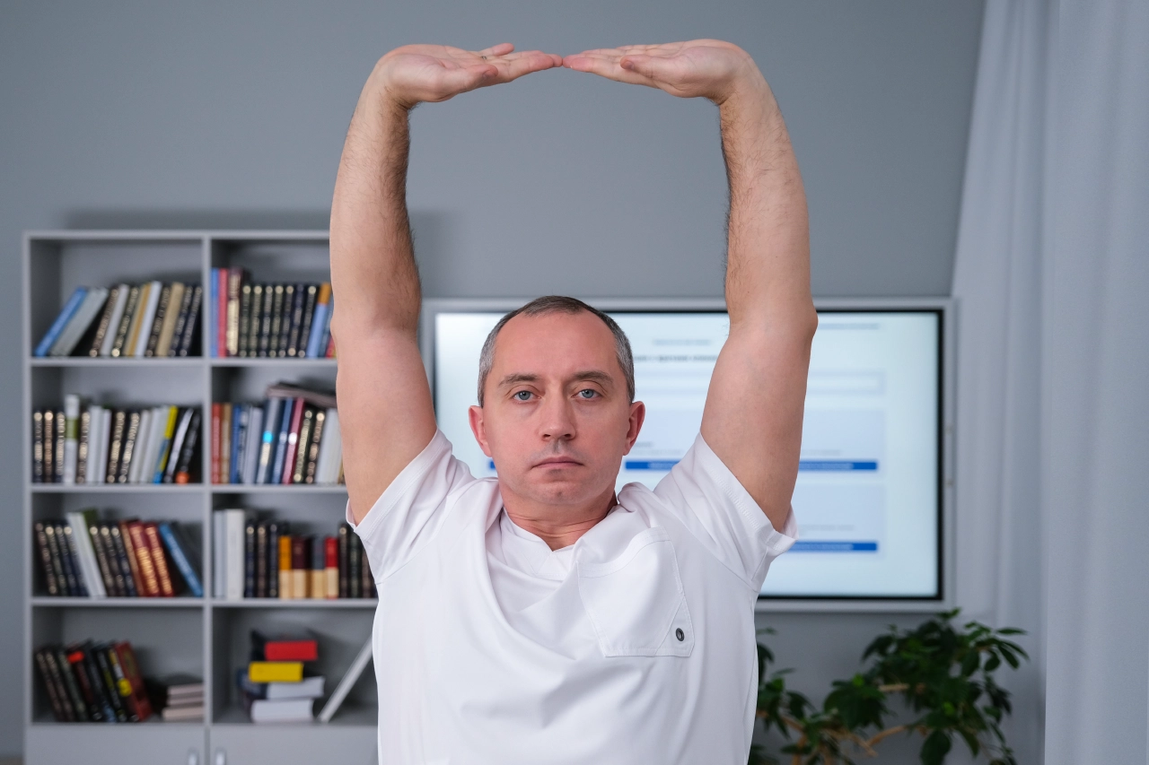 Доктор Шишонин выполняет упражнение "Дерево" из шейной гимснастики